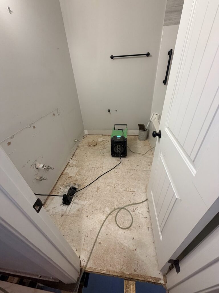 A bathroom undergoing water damage restoration with demolition and drying equipment from Servpro of Athens, GA.