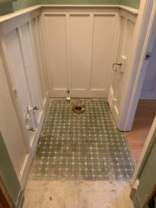 A bathroom with fixtures removed and floor exposed during demolition by Clean Slate Demolition in Rock Hill, SC.