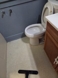A clean bathroom floor being vacuumed by Hm General Cleaning Services in Schenectady, NY
