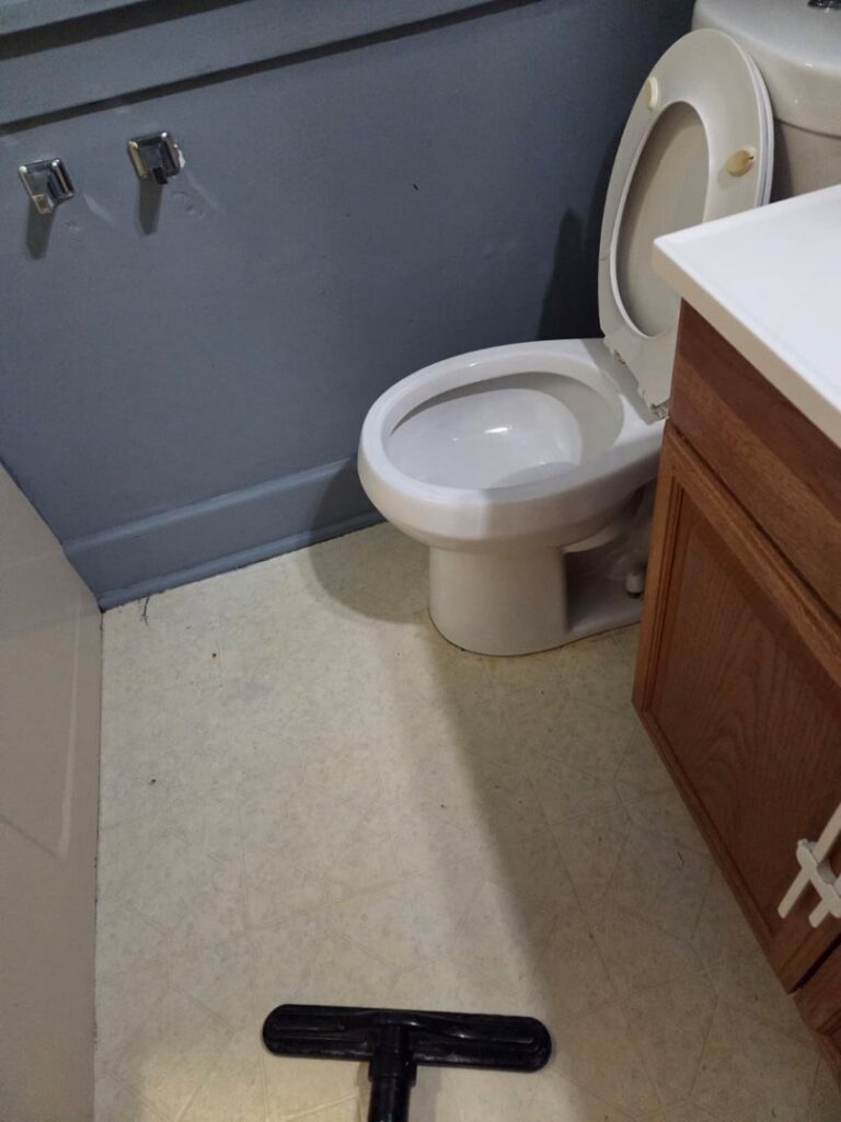 A clean bathroom floor being vacuumed by Hm General Cleaning Services in Schenectady, NY