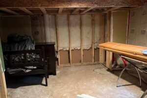 A bathroom floor with a hole and exposed subfloor due to water damage, undergoing demolition in Minneapolis, MN.