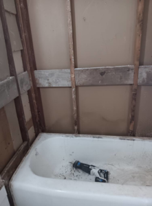 Bathroom wall studs exposed for drying and water damage remediation by Integrity Solutions in Omaha, NE.