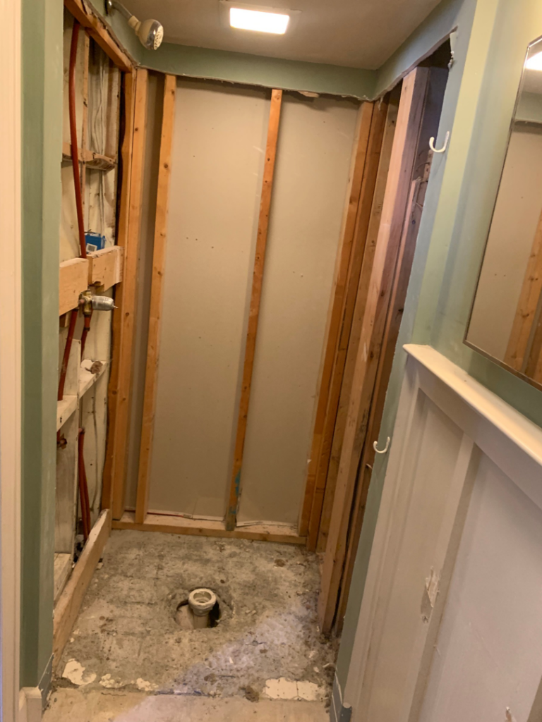 A bathroom with walls stripped to studs, exposing plumbing, during demolition by Clean Slate Demolition in Rock Hill, SC.