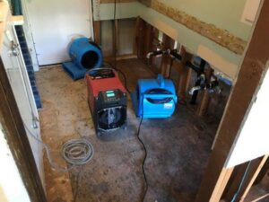 Bathroom area with removed drywall and drying equipment for water damage by Complete Restoration and Construction, LLC in Yakima, WA