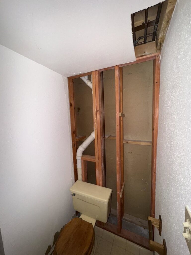 A bathroom undergoing water damage remediation with walls removed, exposing plumbing by 406 Disaster Response in Billings, MT.