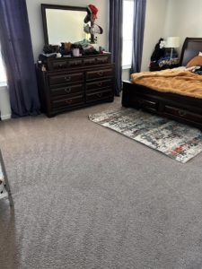 A bedroom carpet showing fresh vacuum lines from Five Star Cleaning Service in Pasadena, MD.
