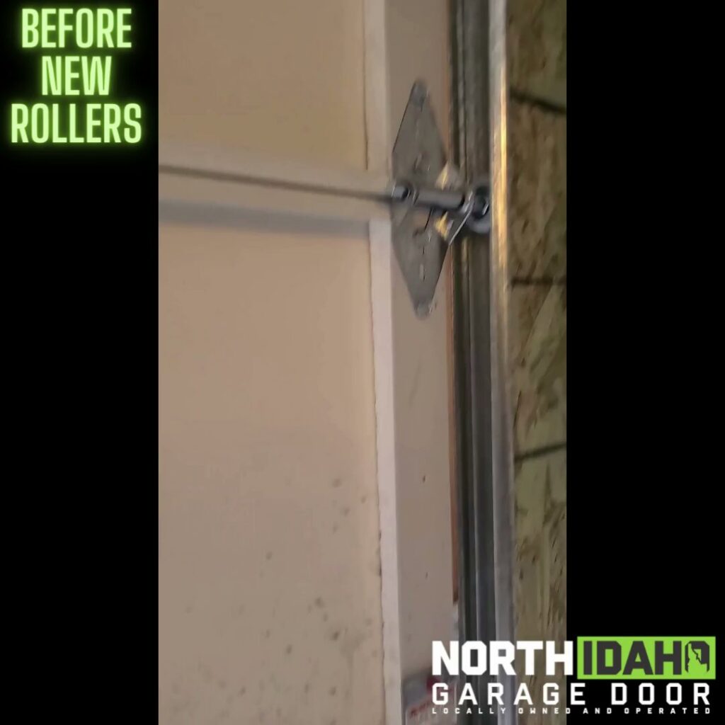 Close-up of an old garage door roller and track before new rollers are installed by North Idaho Garage Door in Coeur d'Alene, ID.