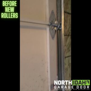 Close-up of an old garage door roller and track before new rollers are installed by North Idaho Garage Door in Coeur d'Alene, ID.