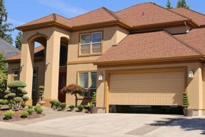 A residential home with a beige garage door partially open, serviced by Sawtooth Garage Doors in Boise, ID.