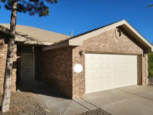 A newly installed beige panel garage door by Spartan Garage Doors and More in Albuquerque, NM.