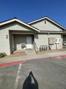A building with light beige horizontal and shake siding on the gable, completed by Bushco Contracting LLC in Fresno, CA.