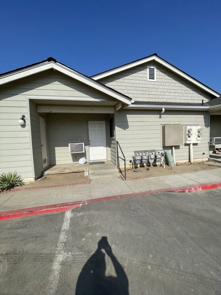 A building with light beige horizontal and shake siding on the gable, completed by Bushco Contracting LLC in Fresno, CA.