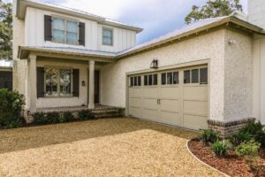 A residential home with a beige panel garage door, showcasing work by Overhead Door Co of Missoula in Missoula, MT.