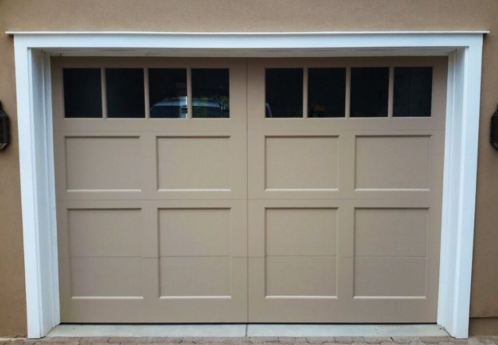 A beige panel garage door with windows along the top, a completed installation by Mark's Garage Door Services in Santa Fe, NM.