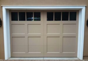 A beige panel garage door with windows along the top, a completed installation by Mark's Garage Door Services in Santa Fe, NM.