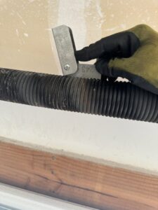 A bent and damaged garage door requiring repair or replacement by Summit Garage Door in Overland Park, KS.