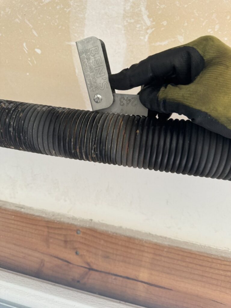 A bent and damaged garage door requiring repair or replacement by Summit Garage Door in Overland Park, KS.