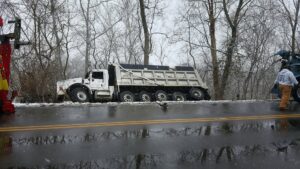 Bevis Towing performing heavy recovery of an overturned truck in a ditch on a snowy road in Cincinnati, OH.