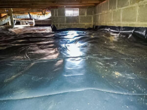 A black vapor barrier installed in a crawl space by Tidewater Home Improvement LLC in Hampton, VA.