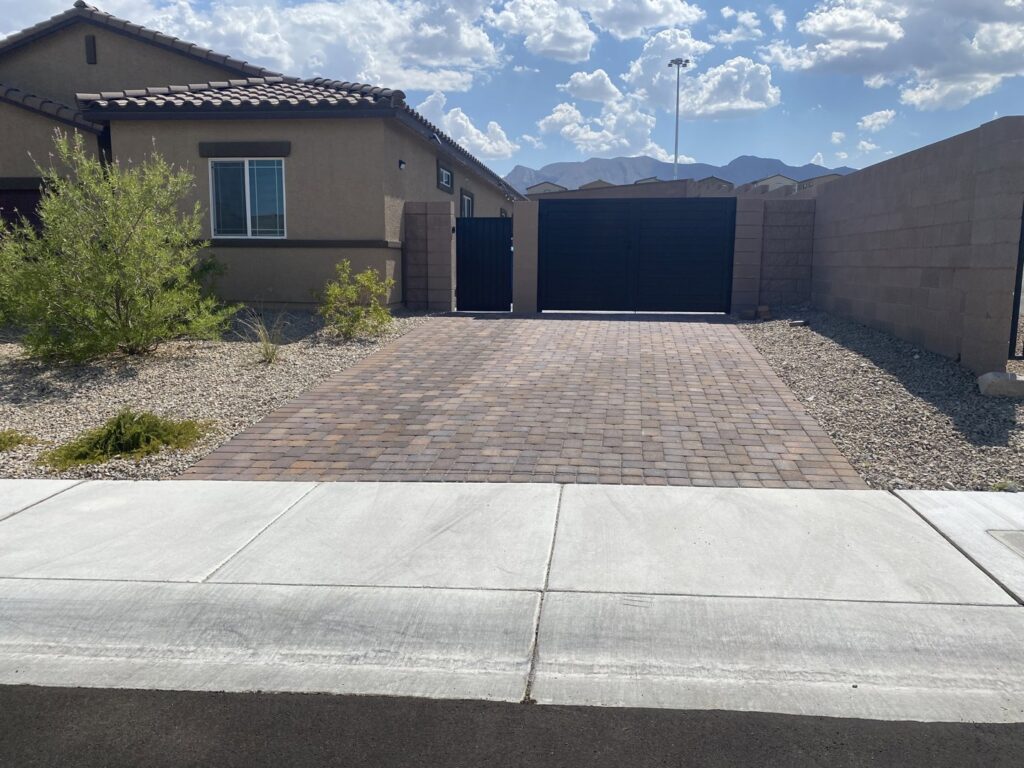 Black double driveway and pedestrian gates installed by Giddy Up Garage Doors & Iron in Las Vegas, NV.