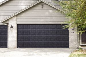 A residential home featuring a black panel garage door installed by Overhead Door Co of Missoula in Missoula, MT.