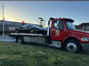 A black sports car being transported on a flatbed tow truck by 101 auto towing inc in San Jose, CA.