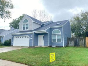 A residential home with newly installed blue and gray siding by Cordell Exteriors Inc in Chesapeake, VA