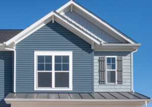 Detail of a house with new blue horizontal siding and light blue shake siding by DL Roofing and Siding in New Haven, CT