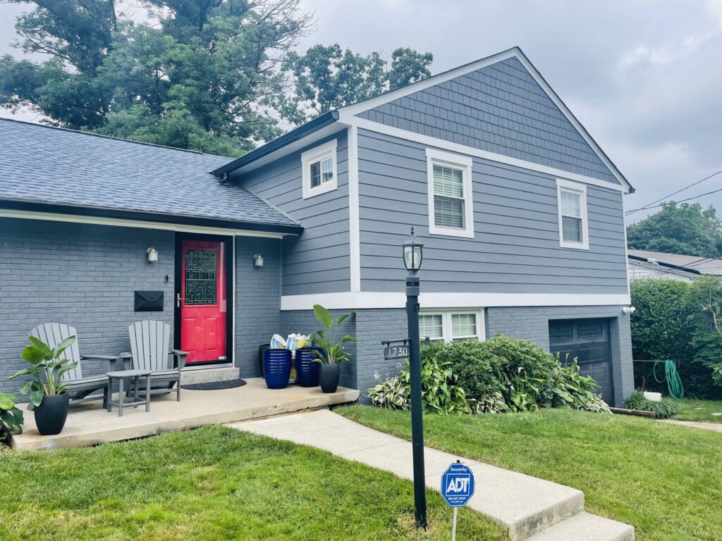 Residential home with new blue horizontal siding and blue shake siding in the gable installed by High Quality Exteriors in Rockville, MD.