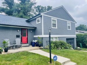 Residential home with new blue horizontal siding and blue shake siding in the gable installed by High Quality Exteriors in Rockville, MD.