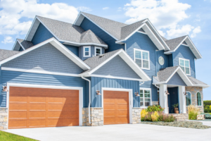 A blue house with two beautiful wood-look garage doors from Jim Dyer Overhead Door in Carson City, NV