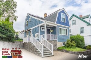 A charming blue house with new siding and crisp white trim, completed by United Home Experts in Ashland, MA