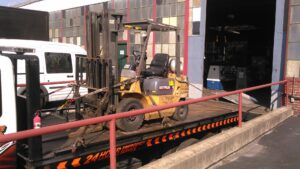 A blue motorcycle secured on a flatbed tow truck by Baltimore Towing Service LLC in Owings Mills, MD.