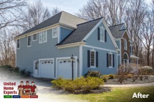A home with new blue siding and white garage doors, completed by United Home Experts in Ashland, MA.