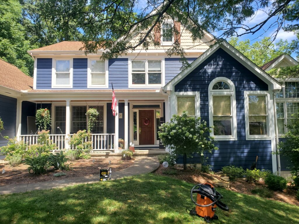 A residential home featuring vibrant blue siding, showcasing exterior work by Stephenson Exteriors LLC in Cincinnati, OH.