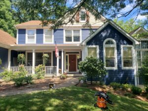 A residential home featuring vibrant blue siding, showcasing exterior work by Stephenson Exteriors LLC in Cincinnati, OH.