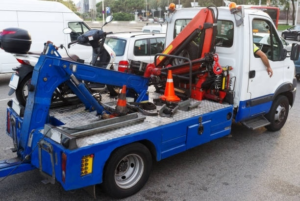 A blue and white tow truck from Bobby's TCB Towing ready for service in Detroit, MI