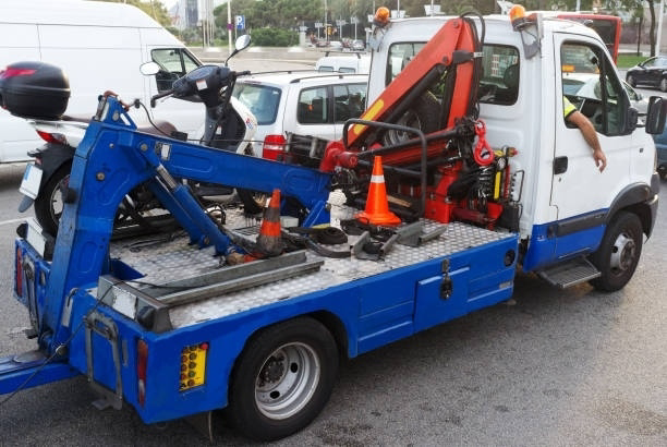 A blue and white tow truck from Bobby's TCB Towing ready for service in Detroit, MI