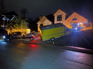 A B&R Towing and Automotive truck recovering a yellow box truck that went off the road at night in Knoxville, TN.