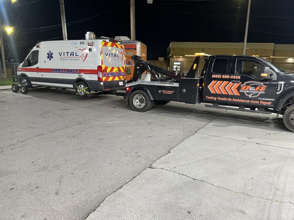 A B&R Towing and Automotive truck towing an ambulance in Knoxville, TN.