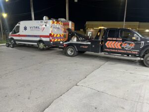 A B&R Towing and Automotive truck towing an ambulance in Knoxville, TN.