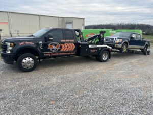 A B&R Towing and Automotive truck towing a Ford pickup truck in Knoxville, TN.