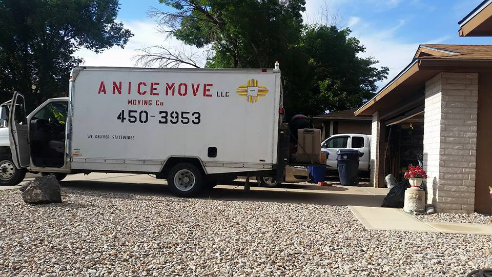 A branded A Nice Move LLC moving truck parked at a residential home in Albuquerque, NM.