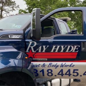 Close-up of Ray Hyde Paint & Body Works branding on the door of a tow truck in Alexandria, LA.