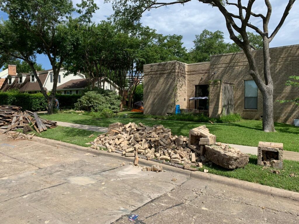A pile of brick demolition rubble on the roadside from a recent structure removal by Vaquero Demolition in Lewisville, TX.