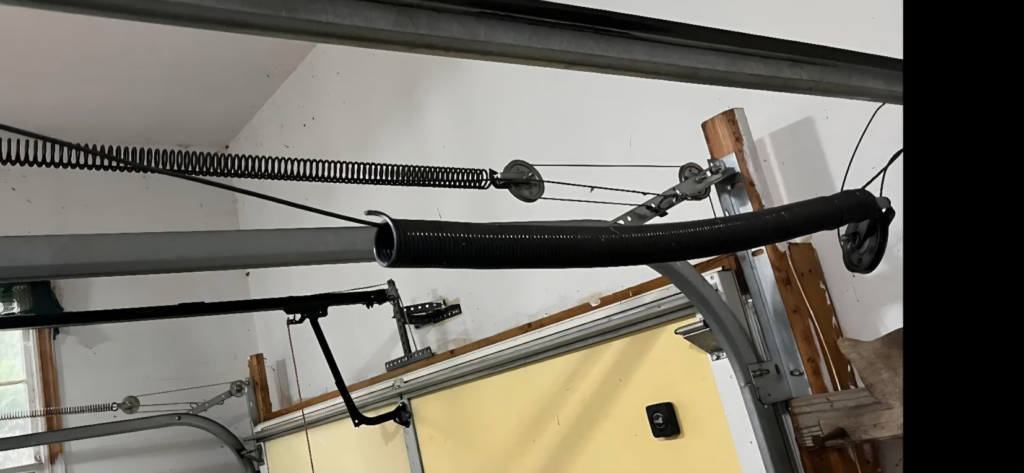A broken garage door spring requiring repair by American Standard Garage Doors - Kansas City Metro in Independence, MO.
