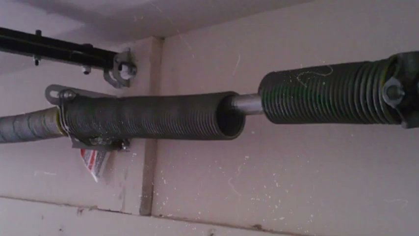 A close-up view of a broken garage door spring, indicating a necessary repair by Central Garage Door Service in Kapolei, HI.