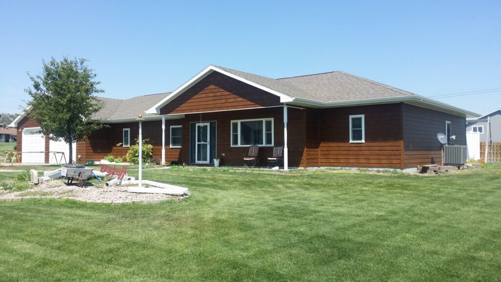 Front view of a house with new brown horizontal siding installed by D.A. Siding & Windows in Grand Island, NE.