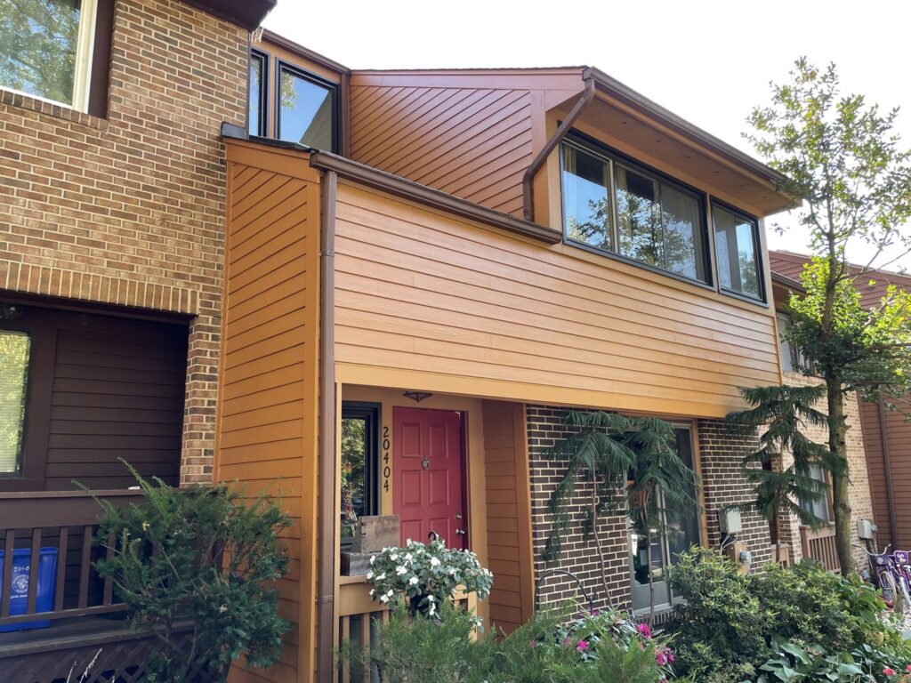 Modern townhouse featuring new brown horizontal siding installed by High Quality Exteriors in Rockville, MD.