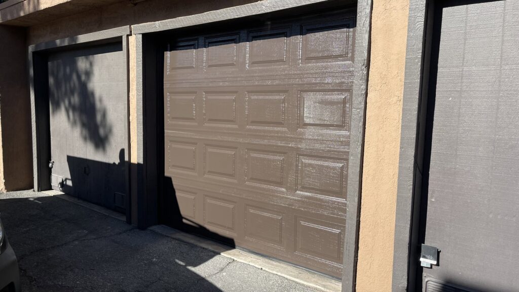 A brown paneled garage door partially open, showing interior, installed by Legacy ODS Garage Door Services in Las Vegas, NV.